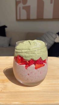 Clear cup with strawberry layer, cut up strawberries, and matcha tea layer. 